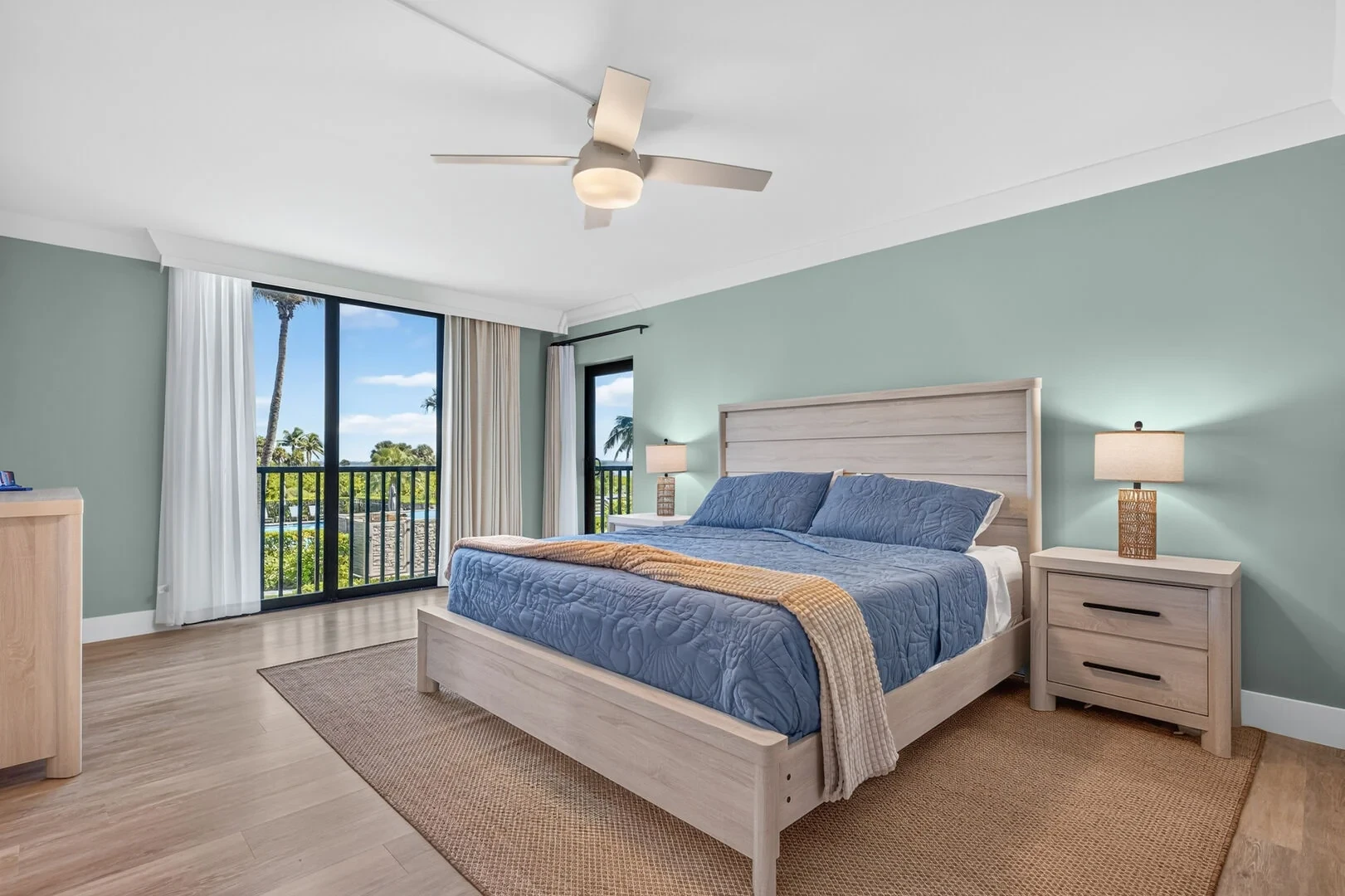 Bedroom with sage green walls and pool view